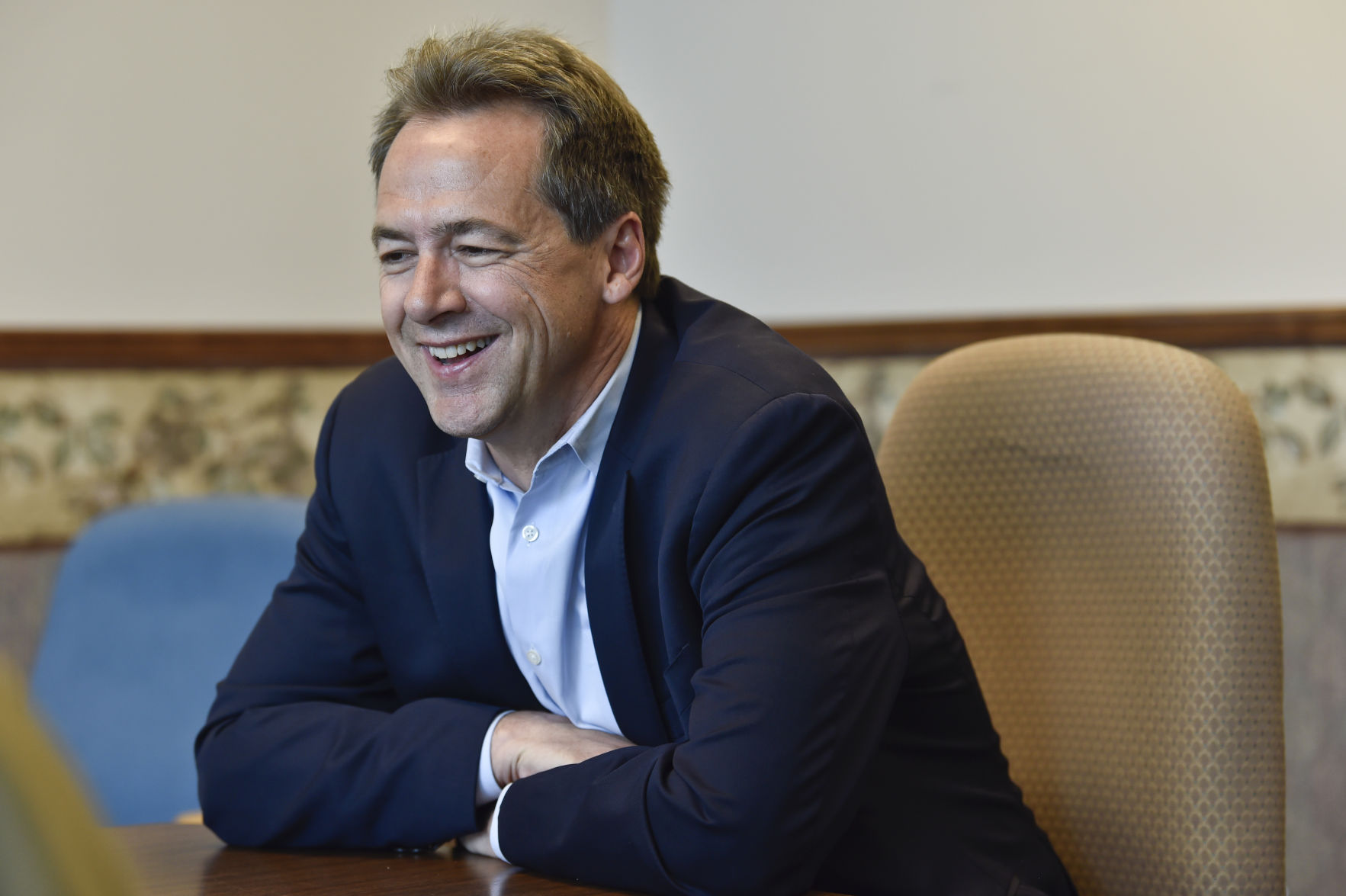 Gov. Steve Bullock talks with a reporter